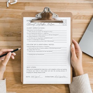 May include: A white client intake form with black text on a clipboard. The form includes sections for client expectations, follow up and additional notes, and next steps. The form also includes spaces for the client's signature and date.