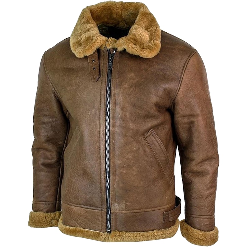 May include: A brown leather jacket with a shearling collar and lining. The jacket has a full zipper closure, a small pocket on the chest, and a buckle detail at the waist. The cuffs are also lined with shearling.