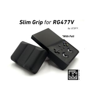 May include: Black Slim Grip for RG477V with felt, next to a black handheld gaming device. The grip has a textured surface. The text "Slim Grip for RG477V" and "by JCSFY" are visible.
