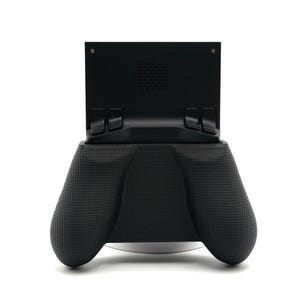 May include: A black handheld gaming device with a textured grip. The device has a screen mount and two ergonomic handles. The design is modern and sleek, suitable for gaming enthusiasts.