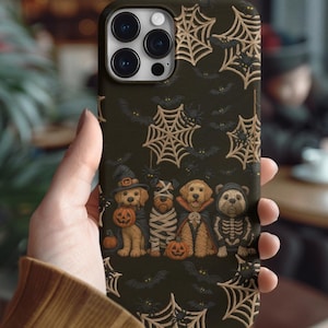 Halloween-themed phone case with four cute dogs in spooky costumes like mummy, skeleton and witch, surrounded by spiderwebs and bats.