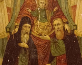 May include: A religious icon painting depicting the Virgin Mary with a crown, holding a baby Jesus. Two figures, likely saints, kneel in prayer on either side of the Virgin Mary. The painting is on a wooden panel and has a worn, aged appearance.