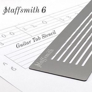 May include: A grey metal guitar tab stencil with the text "Staffsmith" and "Guitar Tab Stencil" on a white background. The stencil has six parallel lines with cut-out sections. Handwritten guitar tab notes are visible.