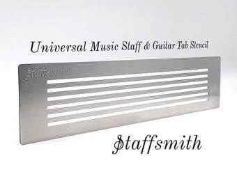 May include: A silver-colored metal stencil for music notation. The stencil has five horizontal lines for the musical staff and the text "Universal Music Staff & Guitar Tab Stencil" and "staffsmith" are printed on the stencil.