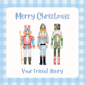 May include: A Christmas card featuring three watercolor nutcracker figurines. The card has a blue and white gingham background and says "Merry Christmas" and "Your Friend, Henry".