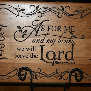 May include: A wooden sign with a decorative border and the text "As for me and my house we will serve the Lord Joshua 24:15".