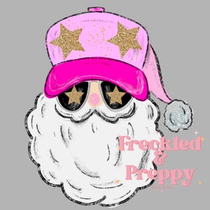 May include: A graphic of Santa Claus wearing a pink baseball cap with gold glitter star accents and sunglasses with star-shaped lenses. The Santa has a white beard and the text "Freckled & Preppy Designs" in pink.