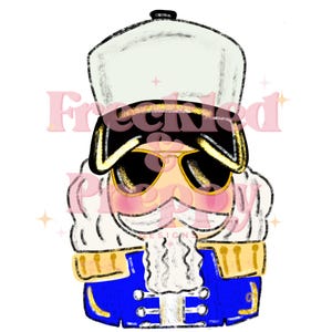 May include: A digital illustration of a nutcracker wearing sunglasses and a military-style hat. The nutcracker has a blue jacket with gold accents, a white wig, and a large white mustache. The image has the text "Freckled Pretty Designs" in pink.