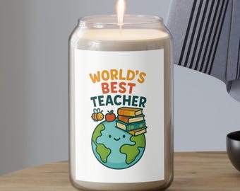 May include: A lit candle in a clear glass jar. The jar has a white label with the text "WORLD'S BEST TEACHER" in orange and blue. The label also features a cartoon globe, books, an apple, and a bee.