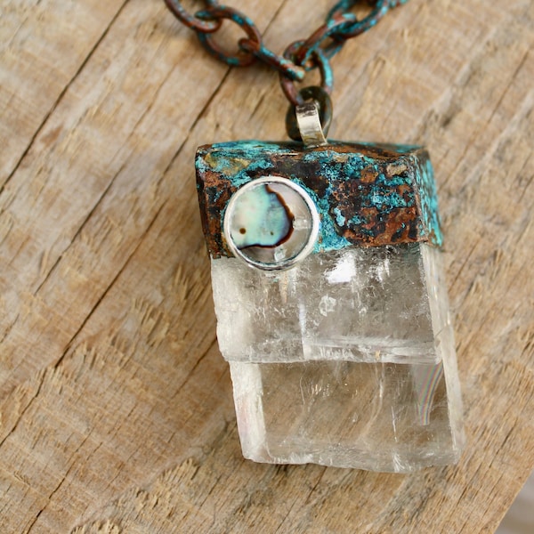 Necklace with a Clear Calcite Crystal Mineral pendant encased in hand verdigris copper with mother of pearl cabachon set in sterling silver