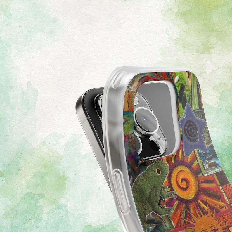 May include: Clear phone case with a colorful, artistic design. The case features a vibrant collage of images, including a green frog, a sun, and a blue star. The design is set against a watercolor background.