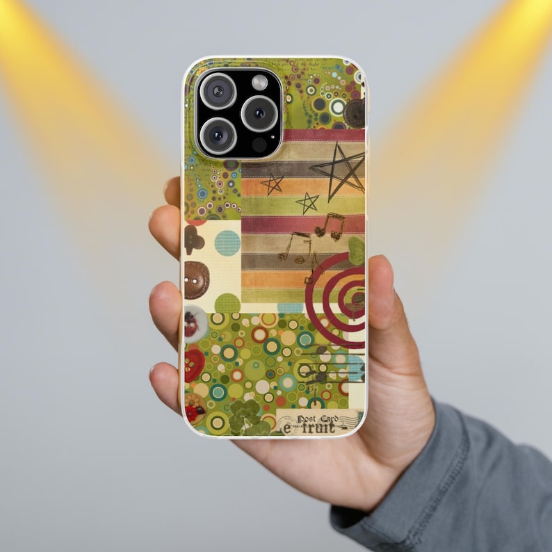 May include: A phone case with a colorful collage design. The case features a mix of patterns, including circles, stripes, and musical notes, with a star and the text "Post Card e-fruit". The case is held in a person's hand.