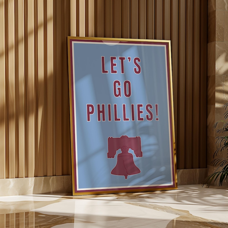 Philadelphia Phillies Baseball Poster in the team's retro or vintage throwback uniform colors maroon red and baby powder blue. States Lets Go Phillies in the maroon red color and the background of the poster is the light blue. A great poster gift for Phillies fans and for kids or children's rooms who want a Philadelphia themed bedroom or game room. Poster comes in a variety of sizes from small sizes to large poster sizes.