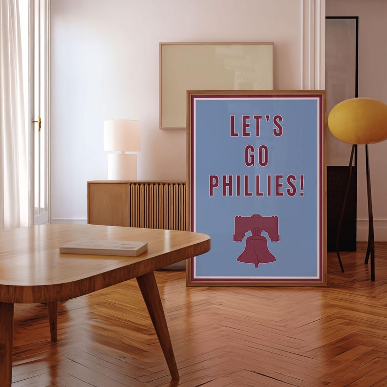Philadelphia Phillies Baseball Poster in the team's retro or vintage throwback uniform colors maroon red and baby powder blue. States Lets Go Phillies in the maroon red color and the background of the poster is the light blue. A great poster gift for Phillies fans and for kids or children's rooms who want a Philadelphia themed bedroom or game room. Poster comes in a variety of sizes from small sizes to large poster sizes.