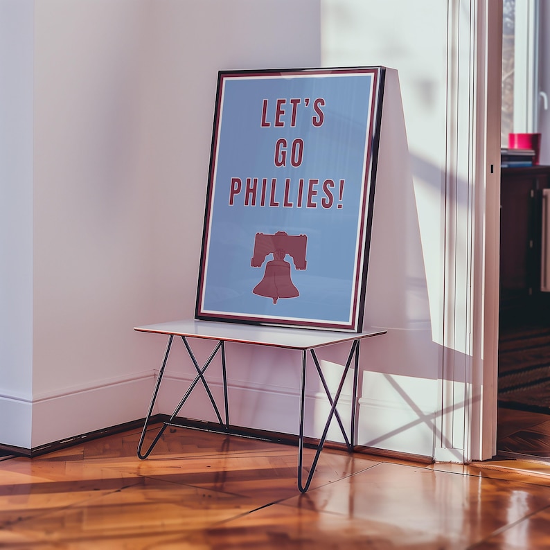 Philadelphia Phillies Baseball Poster in the team's retro or vintage throwback uniform colors maroon red and baby powder blue. States Lets Go Phillies in the maroon red color and the background of the poster is the light blue. A great poster gift for Phillies fans and for kids or children's rooms who want a Philadelphia themed bedroom or game room. Poster comes in a variety of sizes from small sizes to large poster sizes.