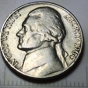1964 Jefferson Nickel No Mint Mark. Die Chip Error on Rim on Reverse.