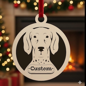 May include: A wooden Christmas ornament featuring a dog's face within a circular frame. The dog has a light-colored face with dark spots and a black background. The word "Custom" is below the dog's face. A red ribbon is attached for hanging.