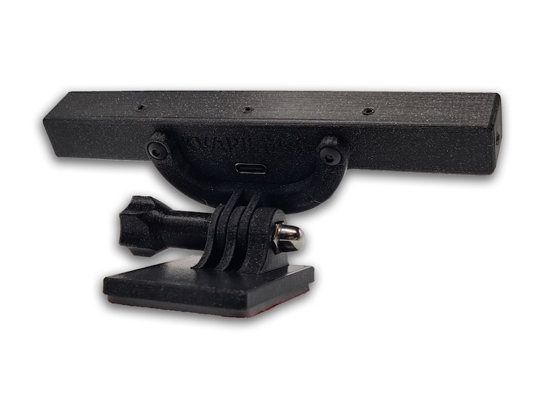 May include: Black plastic camera mount with a GoPro-style attachment and a rectangular bar with four screw holes. The bar has the text "SNAPTV" printed on it.