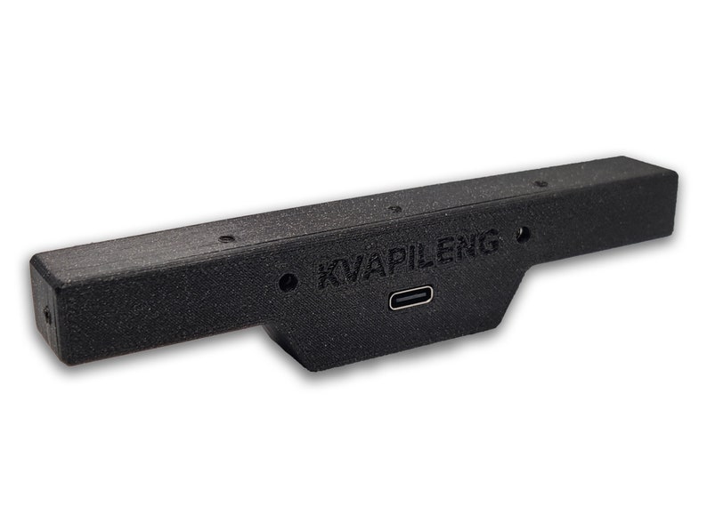 May include: A black plastic device with a USB-C port and the text "KVAPILENG" printed on it.