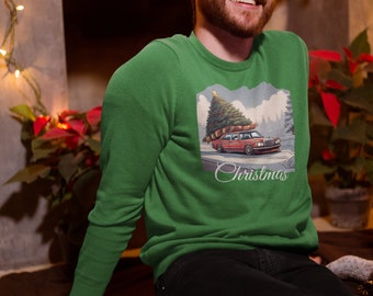 May include: A green Christmas sweater with a red car carrying a Christmas tree. The sweater has the word "Christmas" printed on the bottom.