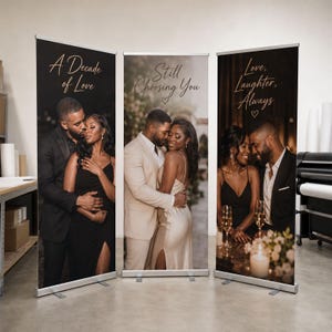 May include: Three vertical retractable banners featuring photographs of a couple. The left banner says A Decade of Love, the center says Still Choosing You with a heart, and the right says Love, Laughter, Always with a heart, all in gold script.