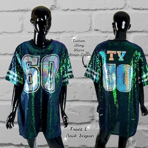 May include: A green and blue sequined jersey with the number "50" on the front and the letters "TY" and the number "50" on the back. The jersey has white stripes on the sleeves.