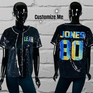May include: Two black sequined baseball jerseys with rainbow lettering. One jersey says "LEAH" and the other says "JONES 80".