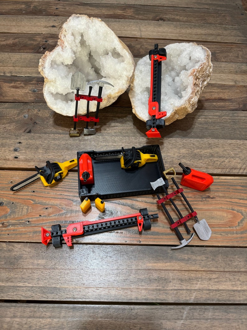 May include: A set of miniature tools, including a pickaxe, shovel, chainsaw, and jack, displayed on a wooden surface with two large white crystal formations.