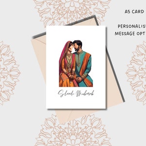 May include: A white card with a couple in traditional Indian clothing. The woman is wearing a pink and orange outfit with gold jewelry. The man is wearing a blue and orange outfit. The text "Shaadi Mubarak" is written in cursive on the card.
