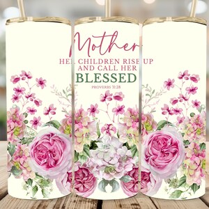 May include: A cream-coloured tumbler featuring a floral design and the words "Mother, Her children rise up and call her blessed, Proverbs 31:28." The floral design includes pink roses and other pink and white flowers.