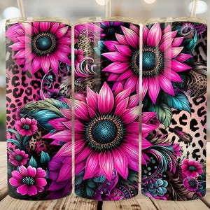 May include: Three stainless steel tumblers with a vibrant floral design. The tumblers feature large pink sunflowers with teal and black accents, set against a pink leopard print background. Each tumbler has a straw.