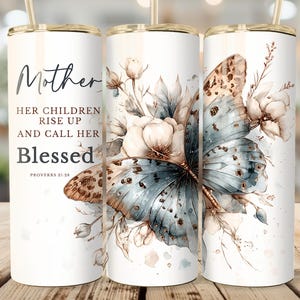 May include: A white 20 oz tumbler with a gold lid and straw. The tumbler features a watercolor design of a butterfly and flowers, with the text "Mother, Her Children Rise Up and Call Her Blessed" and the Bible verse Proverbs 31:28.