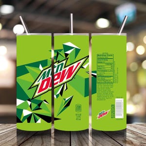 May include: A green tumbler with a stainless steel straw, featuring the Mtn Dew logo in red and white. The design includes geometric shapes and the text "230 Calories" and "16 FL OZ (1 PT) 473 ml". The tumbler has a nutrition facts label on the back.