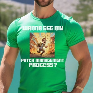 May include: A green t-shirt with the text "WANNA SEE MY PATCH MANAGEMENT PROCESS?" and an illustration of a person running from a fire. The person is wearing brown trousers and is standing in front of a lake and mountains.