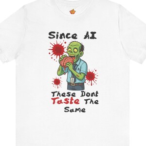 May include: White t-shirt with a cartoon zombie illustration eating a brain, surrounded by red splatter graphics. The text "Since AI, These Don't Taste The Same" is printed above and below the zombie. The shirt has a crew neck and short sleeves.