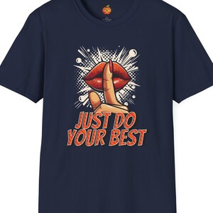 May include: Navy blue t-shirt with a red and white comic book style illustration of a finger over a red mouth with the text "Just Do Your Best".