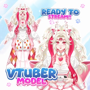 May include: A digital illustration of a four-armed character with long white hair, pink accents, and a heart-shaped chest piece. The character wears a white outfit with diamond patterns. Text reads READY TO STREAM and VTUBER MODEL with paw prints.