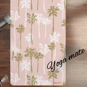 May include: A pink yoga mat with a palm tree pattern. The text "Yoga mate" is written in black cursive on the mat.
