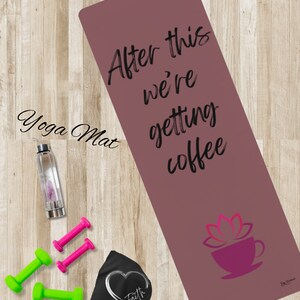May include: A pink yoga mat with the text "After this we're getting coffee" and a pink lotus flower with a coffee cup on it.  The mat is on a wooden surface with a water bottle, two pink dumbbells, and two green dumbbells.