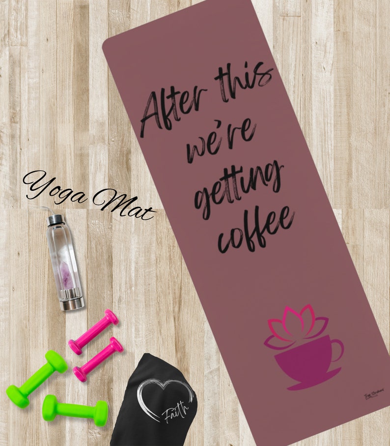 May include: A pink yoga mat with the text "After this we're getting coffee" and a pink lotus flower with a coffee cup on it.  The mat is on a wooden surface with a water bottle, two pink dumbbells, and two green dumbbells.