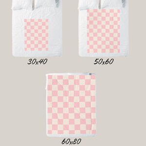 May include: Three pink and white checkered blankets in different sizes: 30x40 inches, 50x60 inches, and 60x80 inches.
