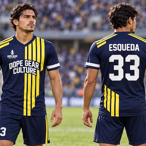 May include: A navy blue soccer jersey and shorts set featuring vertical yellow stripes on the front and back. The jersey displays the text DOPE GEAR CULTURE and a logo on the chest, with the name ESQUEDA and number 33 printed in white on the back.