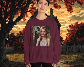 May include: A maroon sweatshirt with a graphic print of a girl with a skull-faced figure behind her. The girl is wearing a white dress with floral details and has long, flowing hair. The background of the graphic is a dark forest setting.