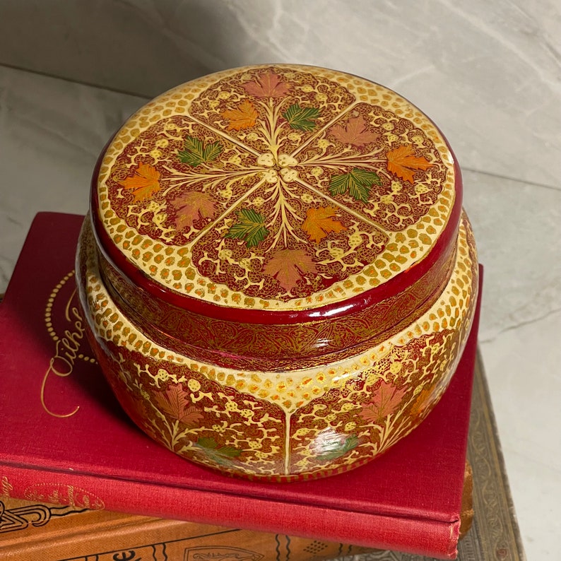 Kashmiri Paper Mache with Brass interior. A very nice trinket box.