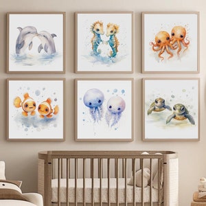 May include: A set of six watercolor prints featuring various sea creatures, including dolphins, seahorses, jellyfish, octopuses, and turtles. The prints are framed in white and arranged in a grid pattern on a wall.