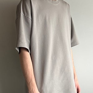 May include: A light gray oversized t-shirt with short sleeves.
