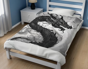 May include: A white twin-sized bedspread with a black and white illustration of a dragon. The dragon is curled up in a spiral shape with its head facing the right side of the image. The dragon's eyes are yellow.
