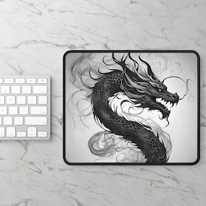 May include: Black and white mousepad featuring a detailed illustration of a dragon. The dragon is depicted with intricate scales and flowing smoke-like elements. The mousepad has a black border and is on a white marble surface.