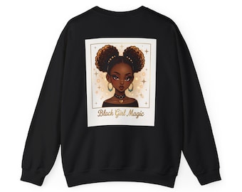 May include: A black long-sleeve sweatshirt featuring a rectangular graphic print on the back. The print shows an illustration of a person with dark skin and two afro puffs, wearing a heart pendant necklace, with the text Black Girl Magic below.