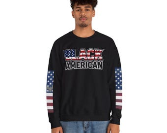 May include: A black long-sleeve sweatshirt featuring the text BLACK AMERICAN in a distressed font filled with the United States flag pattern. The sleeves are decorated with vertical stripes of the American flag, including stars and red and white bars.